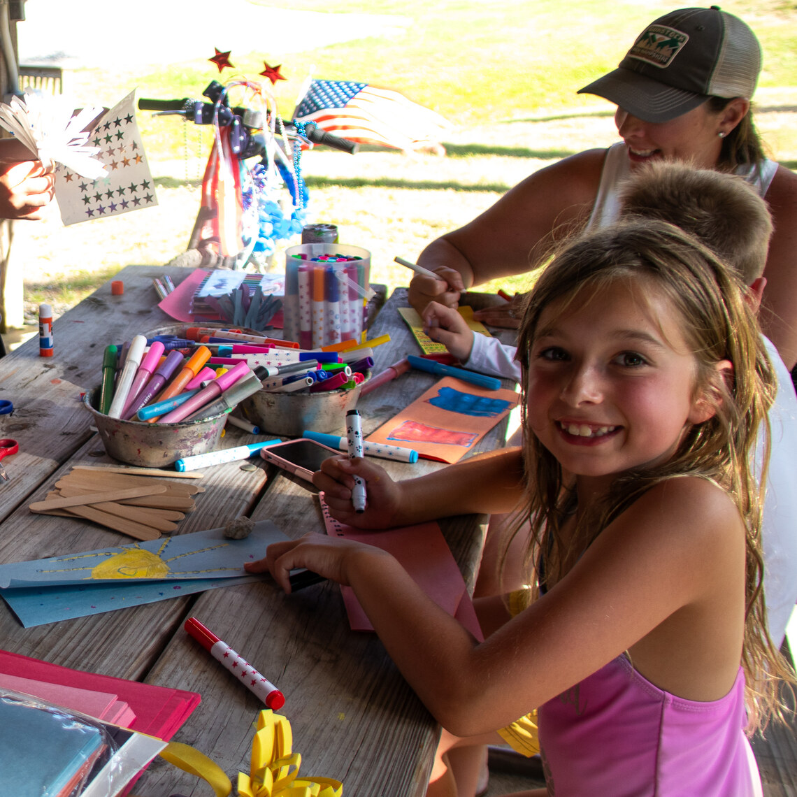 Girl doing crafts at Gunstock Campground